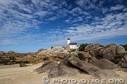 Plage du phare à Brignogan domin&eacute;e par le phare de Pontusval et un ciel moutonneux.