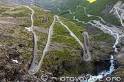 Virages en épingle de la Trollstigen et Stigfossbrua, le pont qui franchit les eaux tumultueuses de la cascade Stigfoss. Trollstigen signifie l'échelle des trolls et désigne la route en lacets qui monte à l'assaut du mur rocheux situé au fond de la vallée d'Isterdalen.